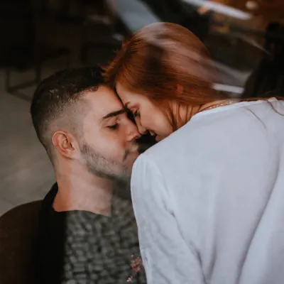couple getting intimate with their noses touching before getting laid