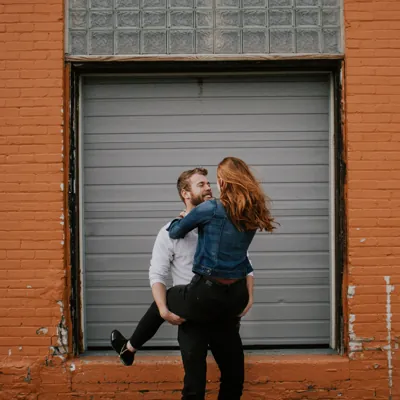 woman jumping into her boyfriends hands to suggest overcoming porn induced erectile dysfunction